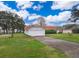 House with attached garage, landscaped yard, and waterfront view at 808 N Shore Dr, Leesburg, FL 34748
