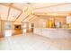 Open kitchen with breakfast bar and chandelier overlooking living room at 808 N Shore Dr, Leesburg, FL 34748