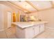 Kitchen features an island, wood beams, and stainless steel appliances at 808 N Shore Dr, Leesburg, FL 34748