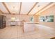 Open kitchen with island, stainless steel appliances, and wood beams at 808 N Shore Dr, Leesburg, FL 34748