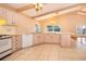 Large kitchen with island, wood beams, and white appliances at 808 N Shore Dr, Leesburg, FL 34748