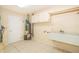 Laundry room with utility sink and storage cabinets at 808 N Shore Dr, Leesburg, FL 34748