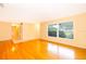 Living room with hardwood floors and large window at 808 N Shore Dr, Leesburg, FL 34748