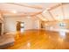 Large living room with hardwood floors, exposed beams, and fireplace at 808 N Shore Dr, Leesburg, FL 34748