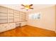 Home office with built-in shelving and hardwood floors at 808 N Shore Dr, Leesburg, FL 34748