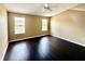 Bright main bedroom features hardwood floors and plenty of natural light from two windows at 8634 Danforth Dr, Windermere, FL 34786