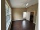 Bedroom with wood-look floors, a ceiling fan, and a view into the laundry room at 8634 Danforth Dr, Windermere, FL 34786