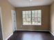 Bedroom with wood-look floors and a large window overlooking the front yard at 8634 Danforth Dr, Windermere, FL 34786