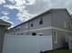Rear exterior view of well-maintained two-story townhome with white vinyl fencing at 8634 Danforth Dr, Windermere, FL 34786