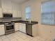 Bright kitchen with stainless appliances, white cabinetry, and neutral countertops at 8634 Danforth Dr, Windermere, FL 34786