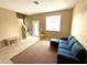 Cozy living room featuring tile flooring, staircase, and view of the outdoors at 8634 Danforth Dr, Windermere, FL 34786
