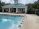 Community pool with adjacent pool house and seating at 8634 Danforth Dr, Windermere, FL 34786
