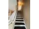 Staircase with stained treads, painted risers, and railing, leading to the upper level at 8634 Danforth Dr, Windermere, FL 34786