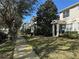 Neighborhood street view of townhouses with mature trees, sidewalks and landscaped front yards at 8634 Danforth Dr, Windermere, FL 34786