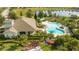 Community pool and clubhouse with lush landscaping at 8794 Eden Cove Dr, Winter Garden, FL 34787