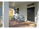 Covered porch with brick floor and two blue chairs at 8794 Eden Cove Dr, Winter Garden, FL 34787