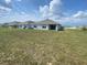 Large backyard with green grass; the back of other houses are visible at 8864 Sw 49Th Cir, Ocala, FL 34476