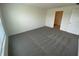 Bedroom with gray carpet and a door leading to the closet at 8864 Sw 49Th Cir, Ocala, FL 34476