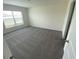 Bright bedroom with soft gray carpet and a large window at 8864 Sw 49Th Cir, Ocala, FL 34476