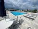 A beautiful community pool with lounge chairs and umbrellas for residents at 8864 Sw 49Th Cir, Ocala, FL 34476