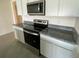 A kitchen with stainless steel appliances, granite countertops and white cabinets at 8864 Sw 49Th Cir, Ocala, FL 34476