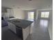 An open kitchen with white cabinetry and granite counters next to stainless steel appliances at 8864 Sw 49Th Cir, Ocala, FL 34476