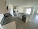 A kitchen with stainless steel appliances, granite countertops and tile flooring at 8864 Sw 49Th Cir, Ocala, FL 34476