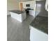 An open kitchen with white cabinetry and granite counters next to stainless steel appliances at 8864 Sw 49Th Cir, Ocala, FL 34476