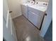 A laundry room with white washer and dryer on tile flooring at 8864 Sw 49Th Cir, Ocala, FL 34476