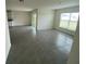 Bright living room featuring large windows and neutral gray tile flooring at 8864 Sw 49Th Cir, Ocala, FL 34476