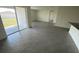 Bright living room with neutral tile flooring and sliding glass doors leading to the patio at 8864 Sw 49Th Cir, Ocala, FL 34476