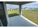 Covered patio overlooking a green lawn with a view of the community entrance sign at 8864 Sw 49Th Cir, Ocala, FL 34476