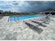Inviting community pool with lounge chairs and clear blue water, perfect for relaxation at 8864 Sw 49Th Cir, Ocala, FL 34476
