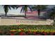 Community entrance sign with landscaping and flowers at 8884 Bengal Ct, Kissimmee, FL 34747