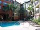 Community pool area with plenty of lounge chairs at 911 N Orange Ave # 127, Orlando, FL 32801