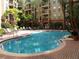 Inviting community pool with surrounding lounge chairs at 911 N Orange Ave # 127, Orlando, FL 32801