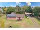 Aerial view of home with solar panels, covered parking, large yard, and mature trees at 9877 7Th Ave, Orlando, FL 32824