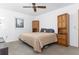 Main bedroom with a large bed and wood armoire at 9877 7Th Ave, Orlando, FL 32824