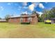 House exterior showcasing a brown house with a yard and solar panels at 9877 7Th Ave, Orlando, FL 32824