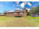 Charming single-story home featuring solar panels and a spacious front yard, offering energy efficiency and curb appeal at 9877 7Th Ave, Orlando, FL 32824