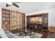 Living room with built-in shelving and a large TV at 9877 7Th Ave, Orlando, FL 32824