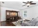 Living room featuring a large TV, comfortable couch, and wood floors at 9877 7Th Ave, Orlando, FL 32824