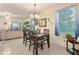 Dining room with a dark wood table and chairs, and a view into the living room at 9979 Schroeder Aly, Winter Garden, FL 34787