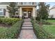 Inviting front entry with brick walkway and well-manicured landscaping at 9979 Schroeder Aly, Winter Garden, FL 34787