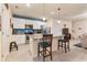 Modern kitchen with granite countertops, white cabinets, and a breakfast bar at 9979 Schroeder Aly, Winter Garden, FL 34787