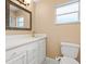 Bathroom with white vanity, quartz countertop, and ornate mirror at 1018 Bear Lake Rd, Apopka, FL 32703