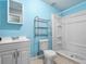 Bathroom with light blue walls, shower, and white vanity at 1018 Bear Lake Rd, Apopka, FL 32703