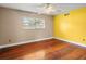 Bright bedroom features wood floors and a yellow accent wall at 1018 Bear Lake Rd, Apopka, FL 32703