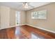 Bedroom with wood floors and view of a nearby bathroom at 1018 Bear Lake Rd, Apopka, FL 32703