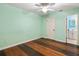 Bedroom with light green walls and wood floors at 1018 Bear Lake Rd, Apopka, FL 32703